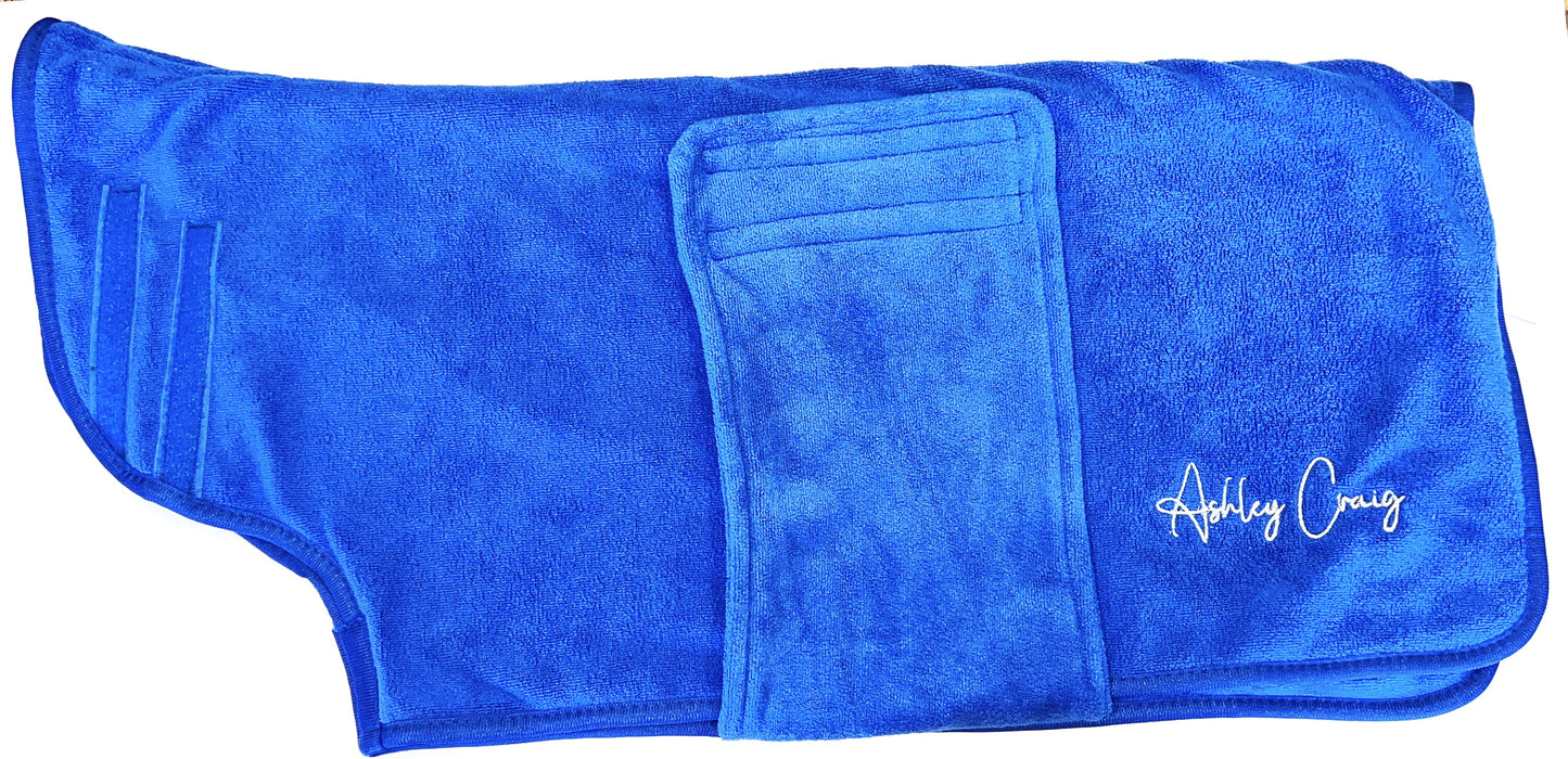 Ashley Craig has created a double-thickness velvet microfiber, pet robes which can absorb up to 50% more water than other microfiber towels, significantly reducing drying times. Ideal for preparing wire hair and flat coated breeds for show. Each robe has a secure Velcro closure and fits over the head with ease. Blue.