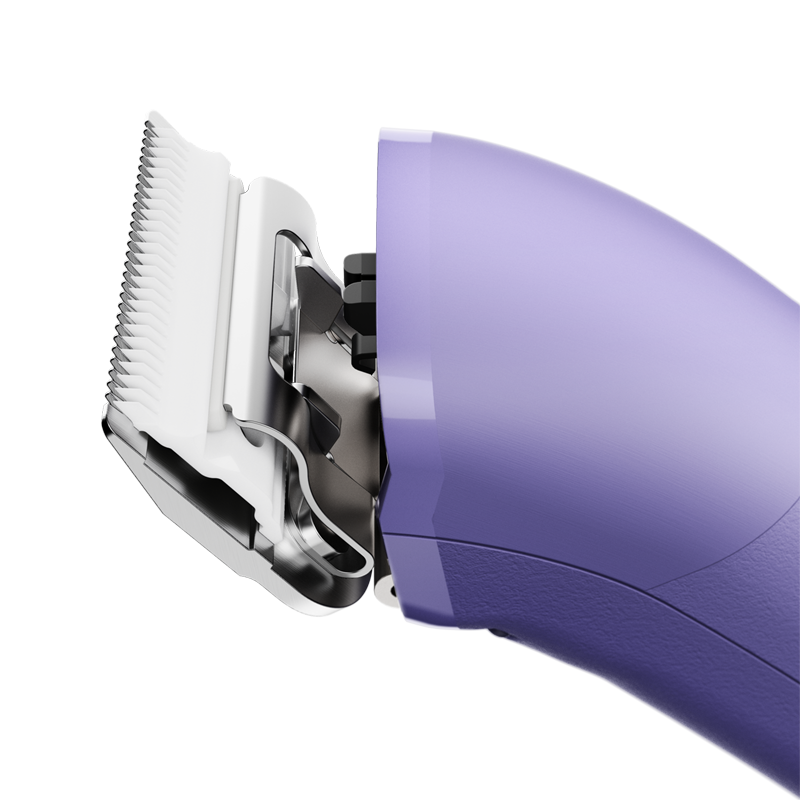 The new Andis eMERGE™ professional pet clipper in light purple was designed for groomers who need and want high speed and power. This single-speed clipper will cut through any coat. The powerful rotary motor achieves 4500 SPM and works with a detachable blade system with wide compatibility make maintenance a breeze. The cord/cordless flexibility and shape with a contoured body and finger grooves helps increase control and reduce hand strain. Side view.