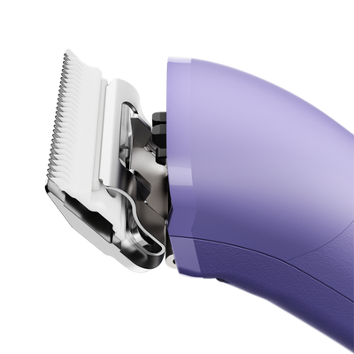 The new Andis eMERGE™ professional pet clipper in light purple was designed for groomers who need and want high speed and power. This single-speed clipper will cut through any coat. The powerful rotary motor achieves 4500 SPM and works with a detachable blade system with wide compatibility make maintenance a breeze. The cord/cordless flexibility and shape with a contoured body and finger grooves helps increase control and reduce hand strain. Side view.